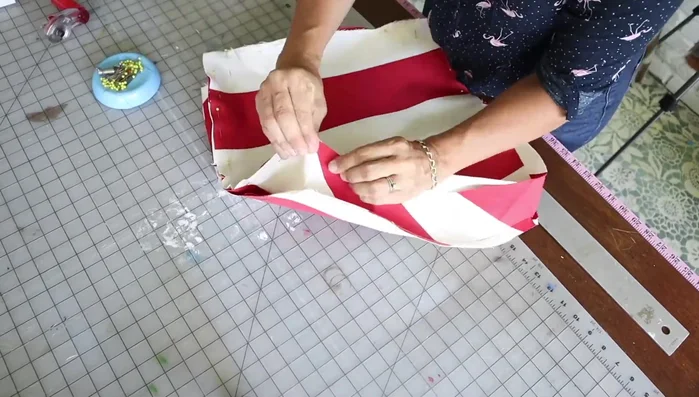 Install the zipper. Partially unzip it, place it in the opening (pull side down), pin it to both sides of the seam allowance, and sew it down closely using a zipper foot.