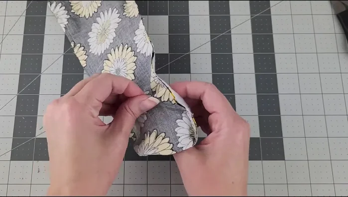 Turn the fabric right side out through the open end. Use a pencil or similar object to push out the corners.