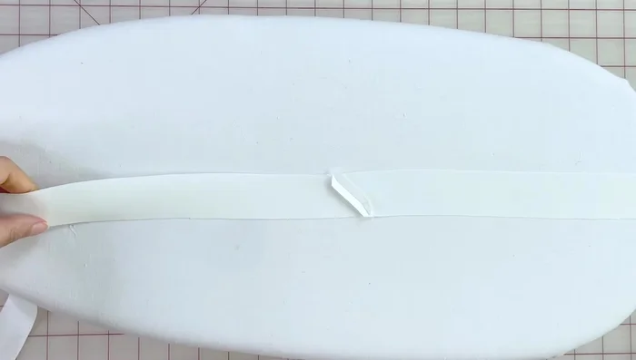 Pin ties to the waistband, measuring and positioning for desired length. Secure ties with small tacks.