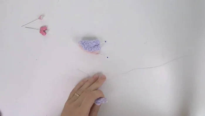 Whip stitch the ears: Use a whip stitch to close the ears, securing the inner ear to the outer ear. Start with the knot inside. Use thread conditioner for easier sewing.