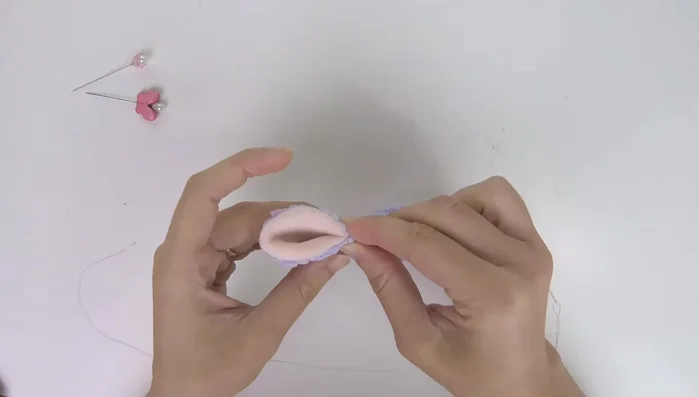 Adjust ear angle: Compare both ears to ensure symmetry. Pin the ears closed, adjusting the angle until you achieve your desired look.