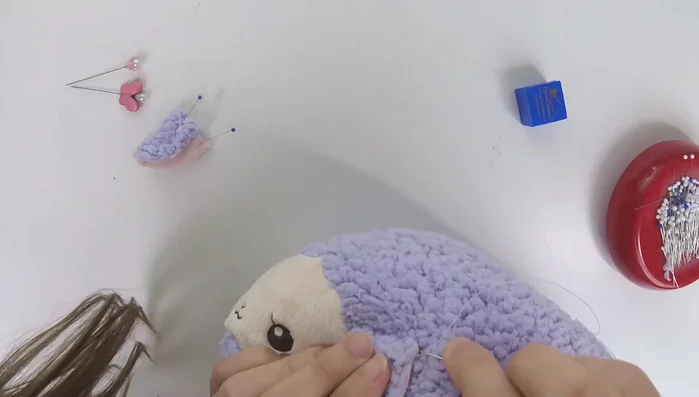 Secure stitches: Pull the thread tightly to prevent loops and ensure the ear stays securely attached. Sew twice around the ear for extra security.