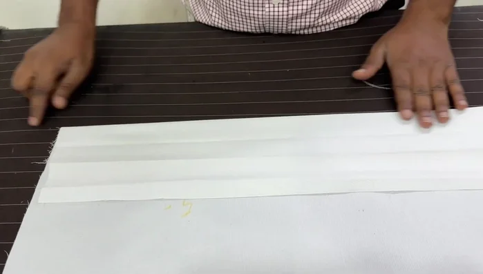 Mark and fold for the plate: Mark 1.5 inches above the top of the fly and 1.5 inches below the bottom of the fly. Fold and iron these sections to create the plate.