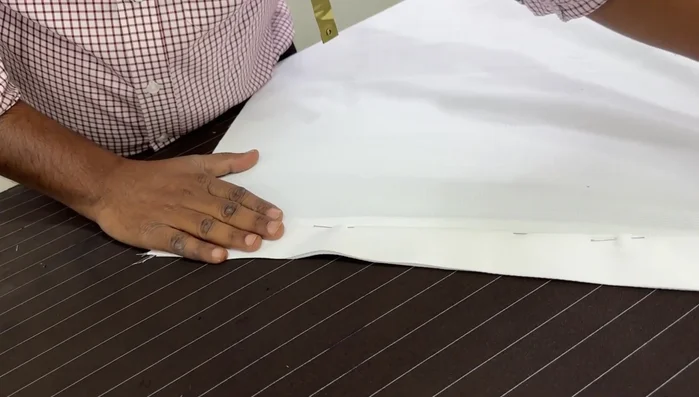 Prepare the front plate: Mark and fold the fabric for the plate, creating a 1/2-inch or quarter-inch fold. This can be done by ironing or stitching.