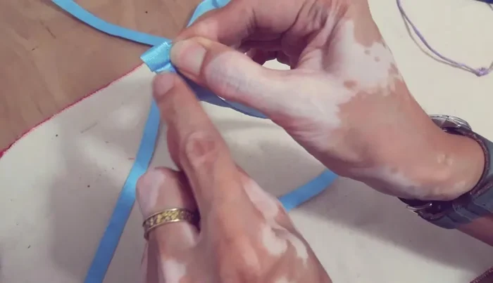 Fold the ends of the straps twice (1/2 inch) and top stitch.