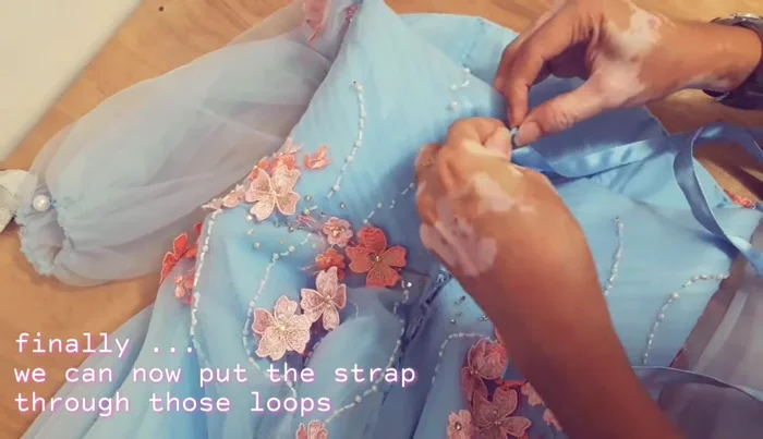 Lace the straps through the loops on the back.