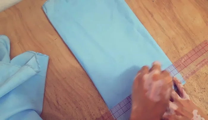 Cut 1.5 yards of fabric for the straps. Fold raw edges, then fold in half and press.