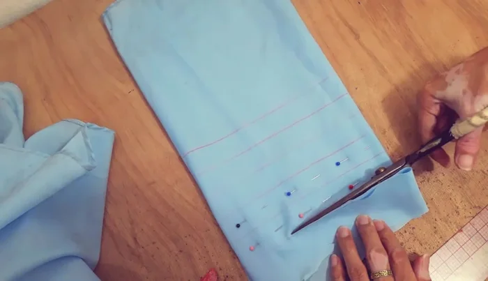 Cut 1.5 yards of fabric for the straps. Fold raw edges, then fold in half and press.