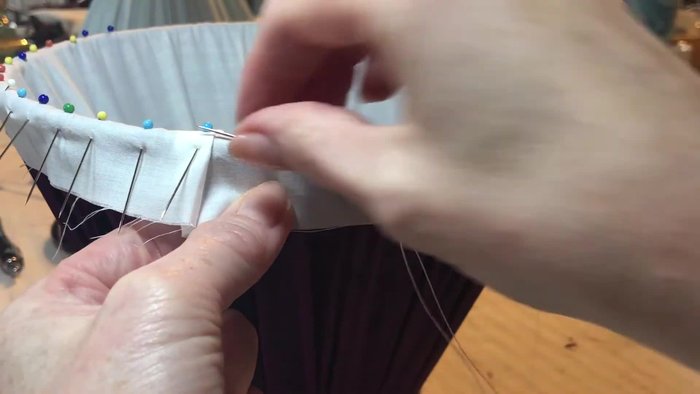 Secure your first stitch: Feed the needle through the fabric, coming out to the front. Stitch into the fabric with a couple of back stitches, working from bottom to top and loop through to secure.