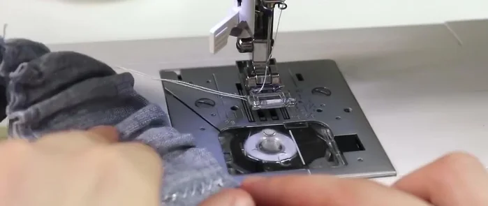 Attach waistband to the skirt top, stretching the waistband while stitching to create a ruffled effect. Use the presser foot width as a guide for even stitching.