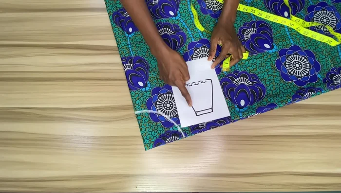 Measure and mark the skirt length: Measure your desired skirt length (minus waistband allowance and add seam allowance), and mark points around the fabric from the waistline to create a curved hemline.