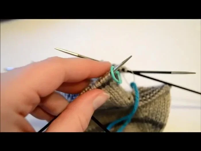 Remove the flap stitches: Using a stitch holder or yarn needle, carefully transfer the increased flap stitches (42 total) to a separate holder. Slip the first stitch purlwise onto the holder, then knit the next stitch, repeating this process across all 42 stitches.