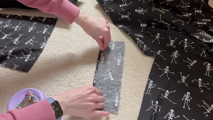 Create a rolled hem along one edge of the remaining cover fabric piece. Repeat for the short edge of the second fabric piece.