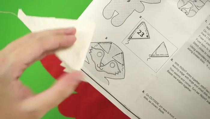 Attach ears: Pin the ears to the front body piece, then place the back body piece on top. Pin everything together, leaving a gap for turning and stuffing.