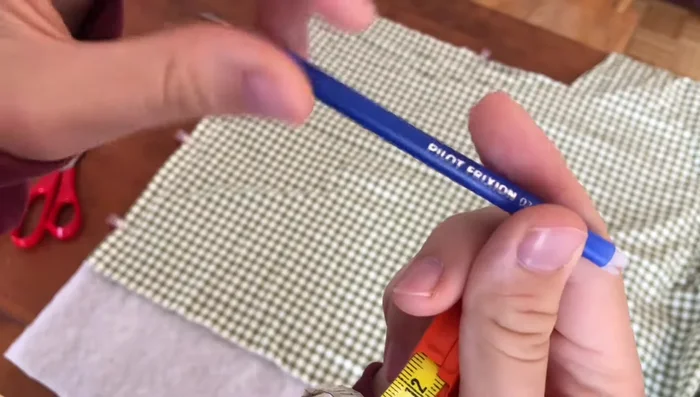 Iron Fabric: Iron the fabric to remove the pen markings.