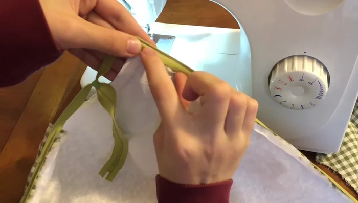 Sew Top and Bottom: Sew the top and bottom of the zipper to the fabric. Don't forget to change to the regular sewing foot.