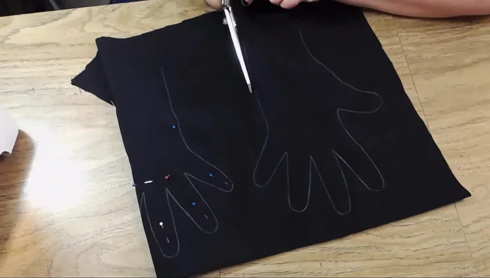 Fold and stitch the wrist area to create a cuff for a standard glove.