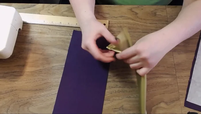 Position and sew the straps to the cuff, ensuring they sit correctly on both the front and back.