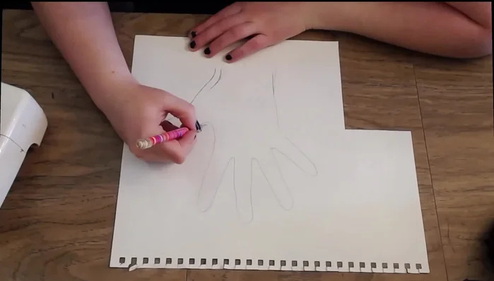 Trace your hand onto sketch paper, adding seam allowance (1/8 - 1/4 inch).