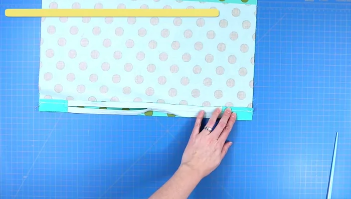 Attach zipper to the larger panel half: Place zipper edge along the edge of the larger panel, sew using a zipper foot. Secure with back stitches.