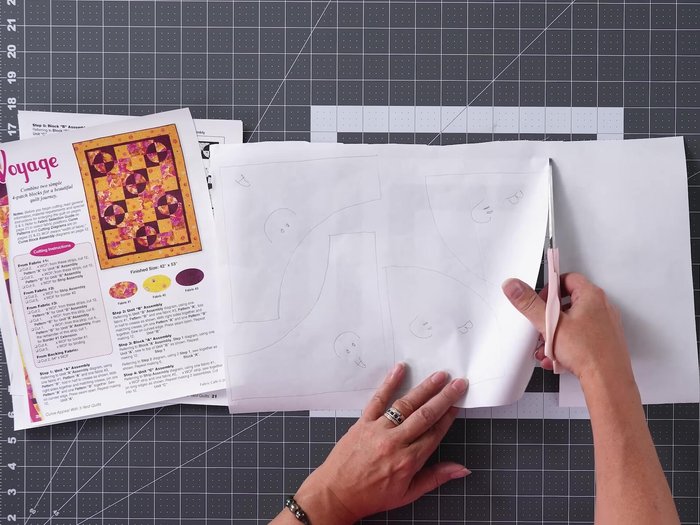 Cut Fabric Strips and Curves: Cut fabric strips for all three fabrics. Keeping fabric folded in half, press freezer paper templates onto fabric (shiny side down) using high heat without steam. Trim excess fabric and stack layers before cutting curves using the freezer paper as a guide. Cut four curves at a time.