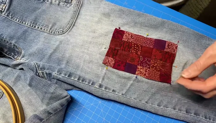 Embroider around the perimeter of the patch with a blanket stitch and straight stitch in thinner areas.