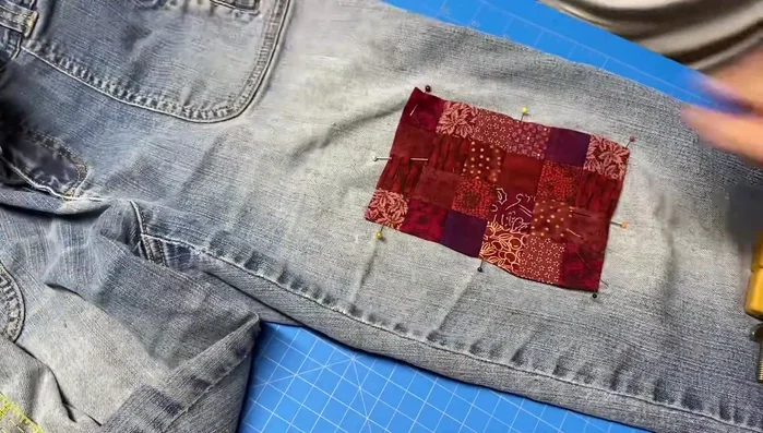 Embroider around the perimeter of the patch with a blanket stitch and straight stitch in thinner areas.