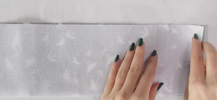 Fuse interfacing to the wrong side of the fabric using a press cloth and iron.