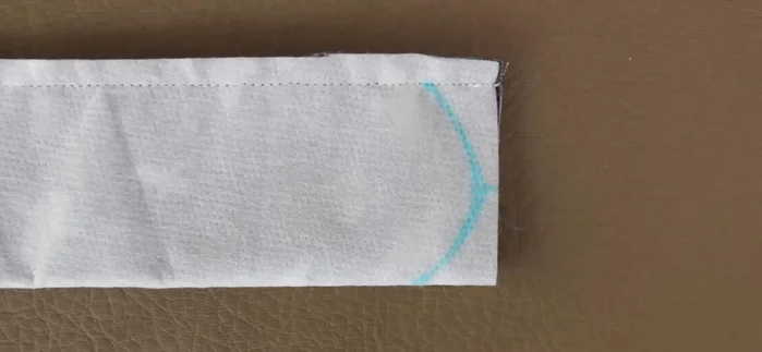 Trim seam allowance, leaving ¼ inch. Draw desired shape on one end and stitch along the line.