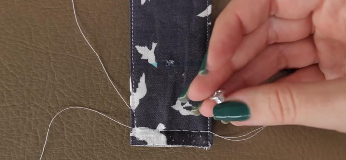 Slip the fabric through the buckle, then fold and hand-sew the raw edge onto the fold line.