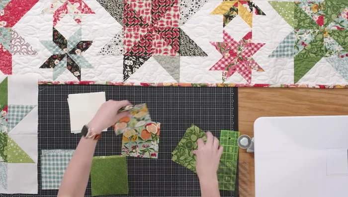 Trim each sewn piece to 4.5 inches using a squaring tool, aligning the stitch line with the dashed line on the ruler.