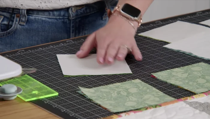 Trim each sewn piece to 4.5 inches using a squaring tool, aligning the stitch line with the dashed line on the ruler.