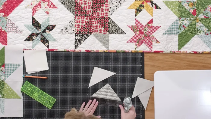 Trim each sewn piece to 4.5 inches using a squaring tool, aligning the stitch line with the dashed line on the ruler.