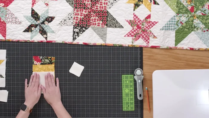 Gather fabrics: two of each contrasting print (fruit, yellow), two background fabrics, and four 2.5in background squares.