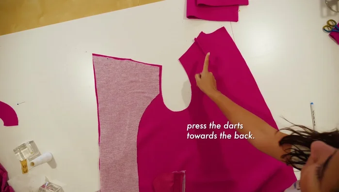 Pin the under collar to the shoulders and back neck, sew at ½ inch seam allowance, and optionally baste before machine stitching.