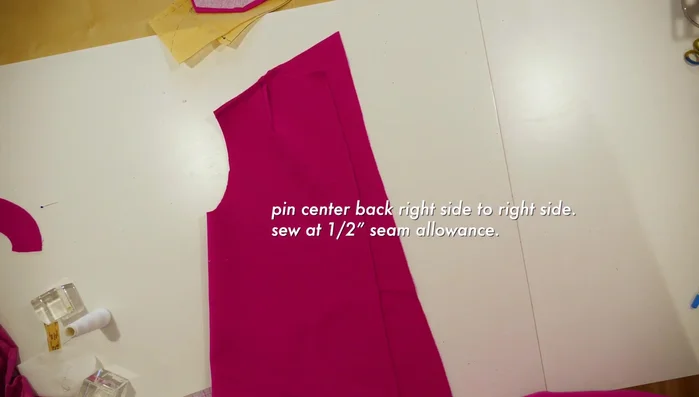 Pin the under collar to the shoulders and back neck, sew at ½ inch seam allowance, and optionally baste before machine stitching.