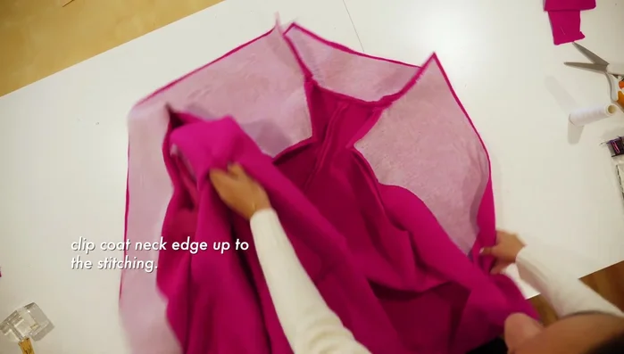 Clip the coat neck edge up to the stitching for a better lay.