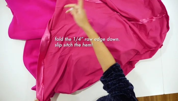 Fold raw edge down ¼ inch and slip stitch the hem.