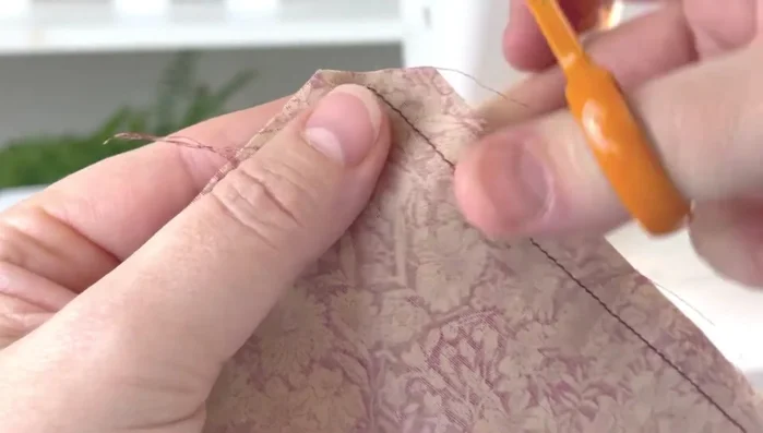 Turn and shape: Turn the bag inside out through the lining gap. Poke out the corners of both the outer and inner fabrics.