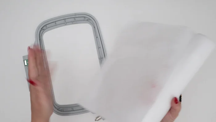 Mark your scarf and stabilizer: Accurately mark the desired embroidery placement on both the scarf and the stabilizer. Use a method that will easily remove later. Align the marks to ensure precise placement.