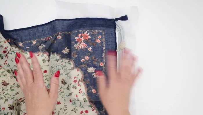 Add the topping stabilizer: Layer the clear wash-away stabilizer over the scarf, ensuring it's smooth and taut.