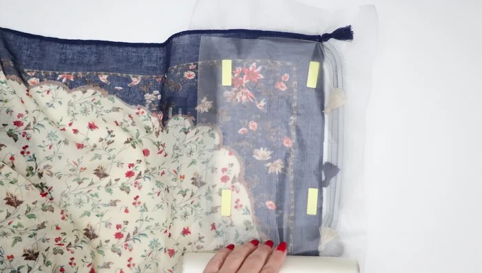 Add the topping stabilizer: Layer the clear wash-away stabilizer over the scarf, ensuring it's smooth and taut.