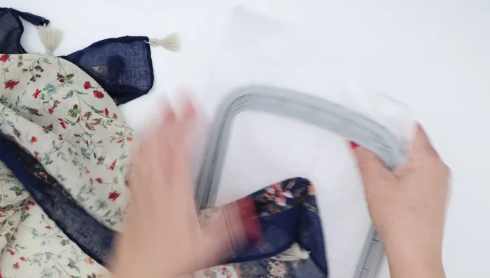 Remove the backing stabilizer: Carefully cut away as much of the mesh stabilizer as possible using duckbill scissors to avoid damaging the scarf. Wash away any remaining stabilizer.