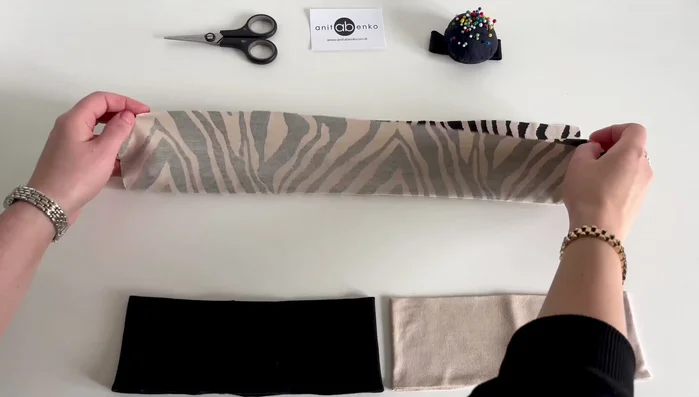 Fold the fabric in half with right sides together, leaving one inch open on each short side. Pin the edges.