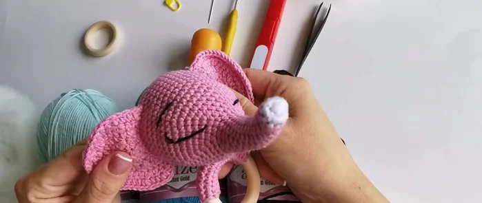 Crochet the elephant: Follow the crochet pattern (not provided in this transcript). Use your chosen blue yarns and 2.5 mm hook.