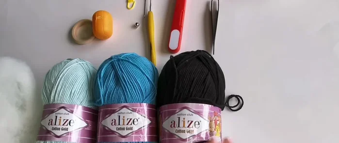 Insert the rattle: Insert the prepared rattle insert (bell in plastic container) into the elephant before completely closing up the crochet piece.