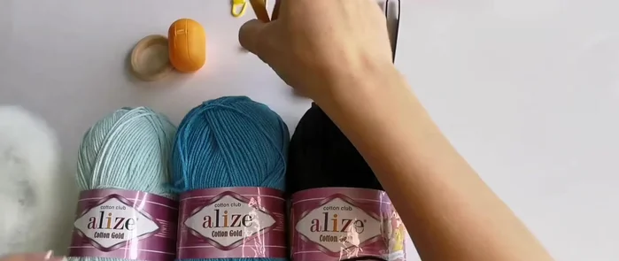 Prepare the rattle insert: Place a bell (or more for a louder sound) inside a small plastic container (like a Kinder Surprise egg). Secure the bell with tape to prevent it from coming out.