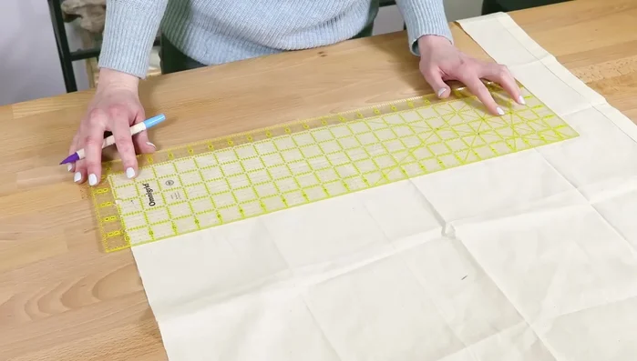 Cut upper lining pieces: Cut two lining fabric pieces 2.5 inches high and same width as other pieces. These will be visible above the zipper.