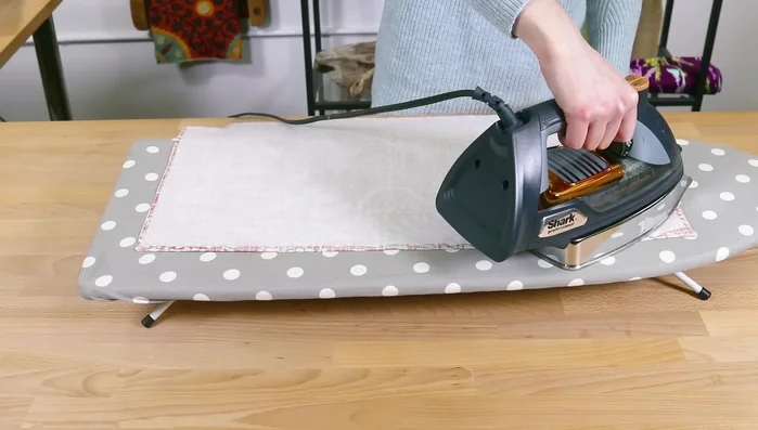 Fuse interfacing: Center stabilizer on back of outer pieces and upper lining pieces. Press for 10 seconds per section. Repeat for other pieces.