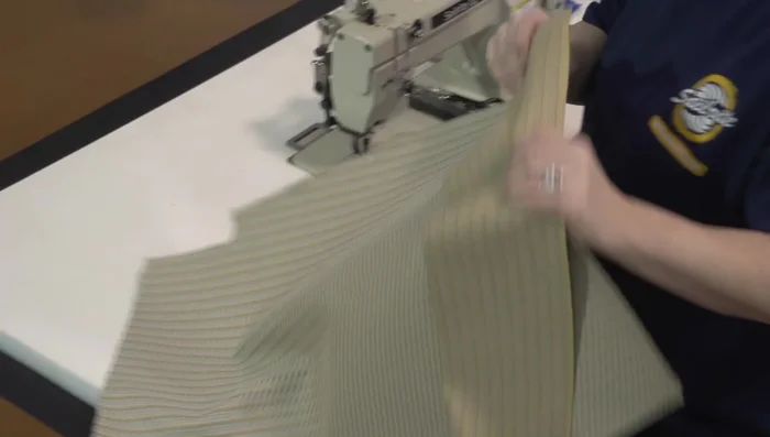 Sew boxing strips to the top fabric piece. Use a hot knife to prevent unraveling.